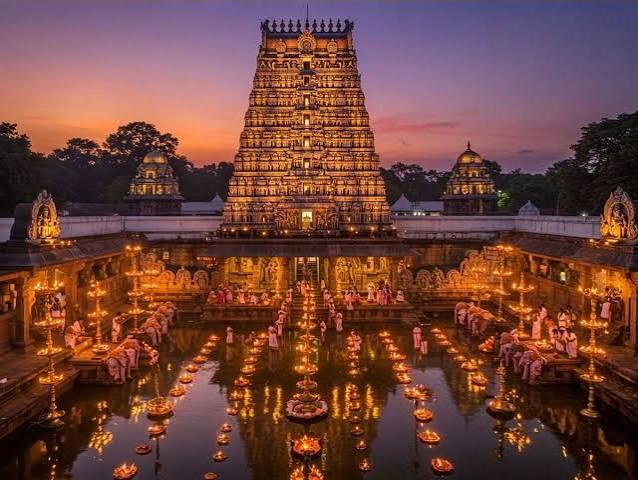 Temple gopuram lit with diyas at dusk - the devotion behind Sidhiti